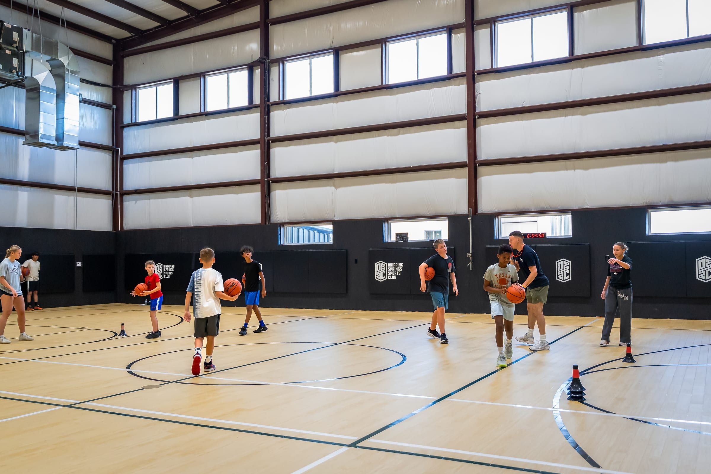 Basketball players spread across the full court during a skill lab