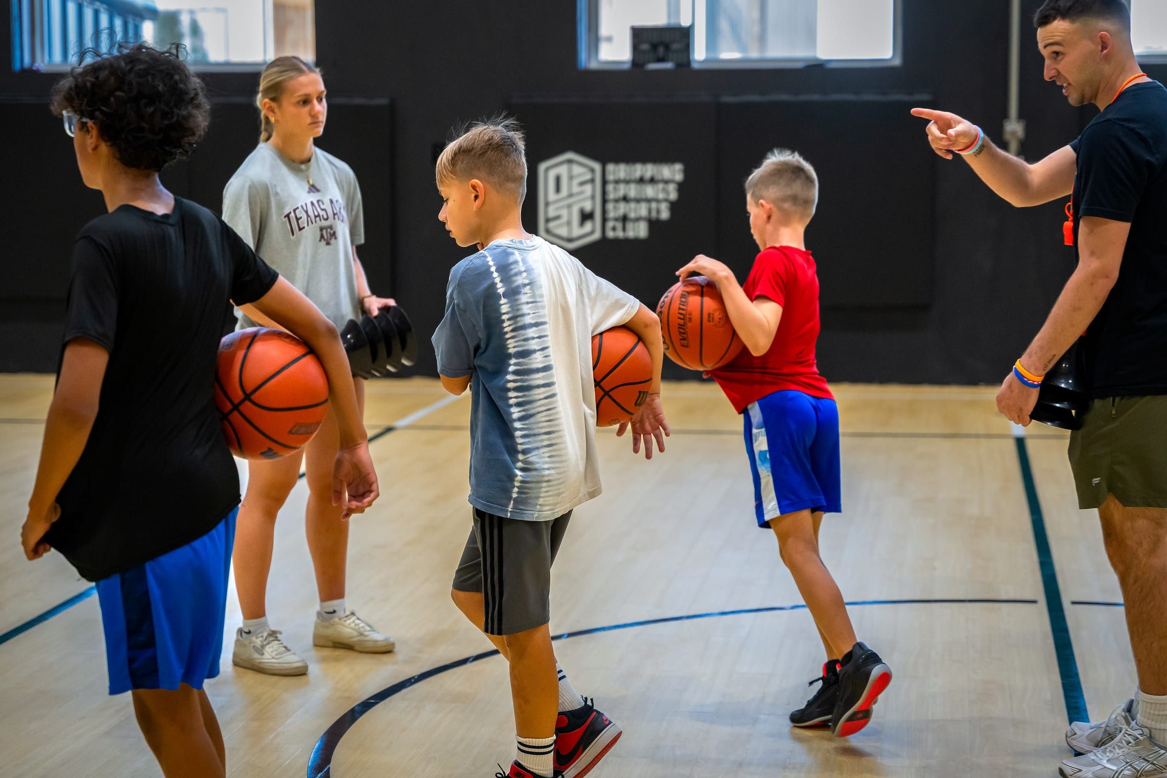 Young players each holding a basketball during a skill lab
