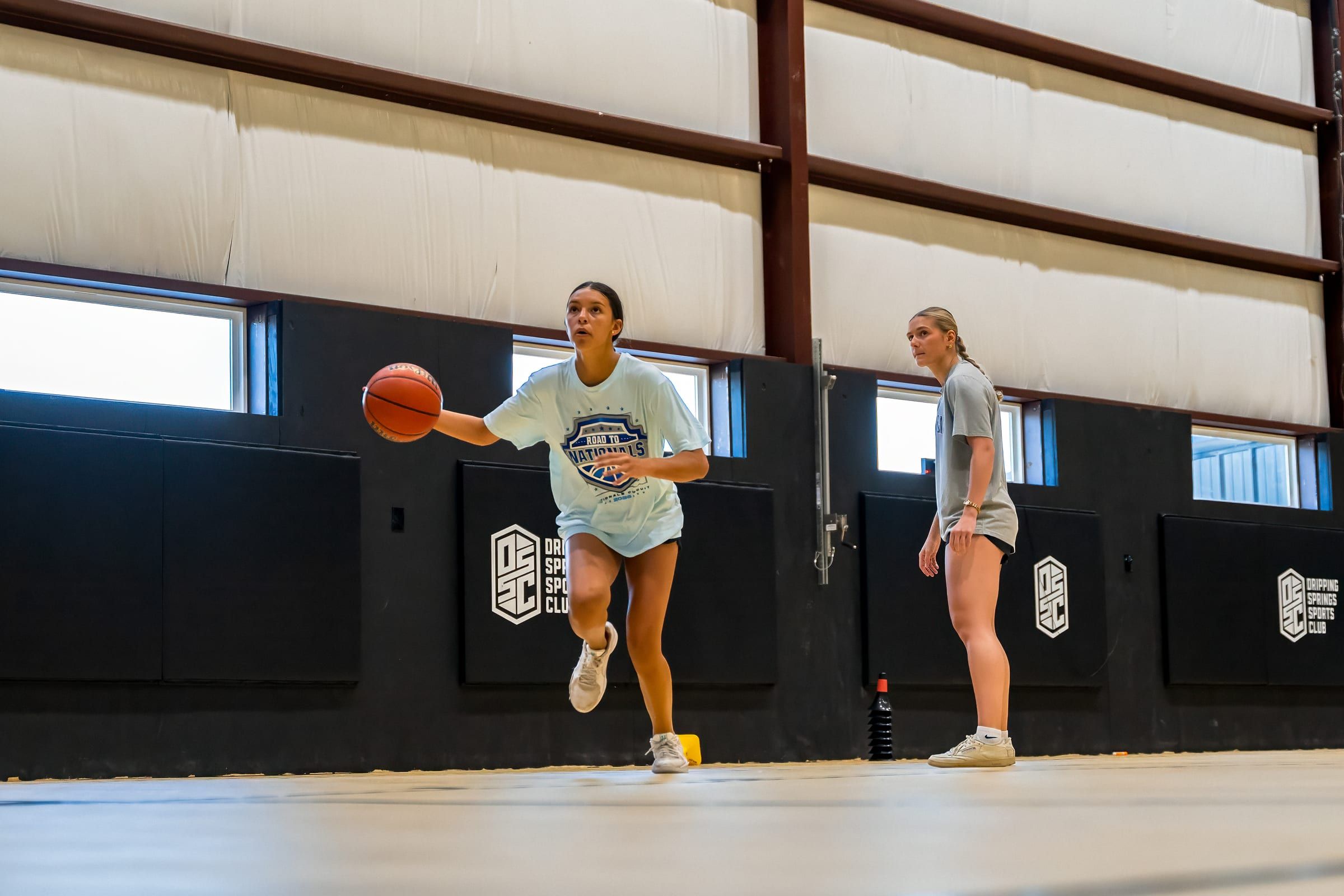 The full court inside the Warehouse during a youth basketball session, DSSC banner on the wall