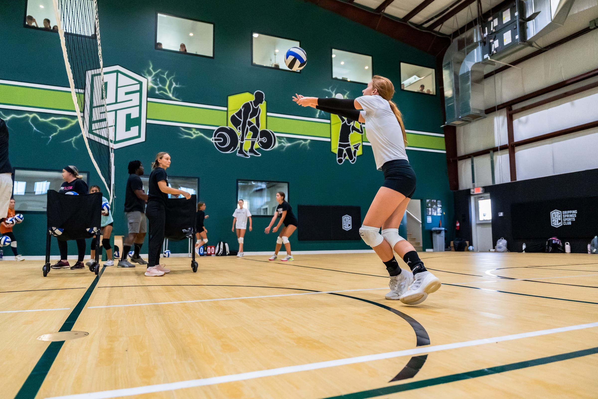 A player rising to attack at the net during a volleyball pod