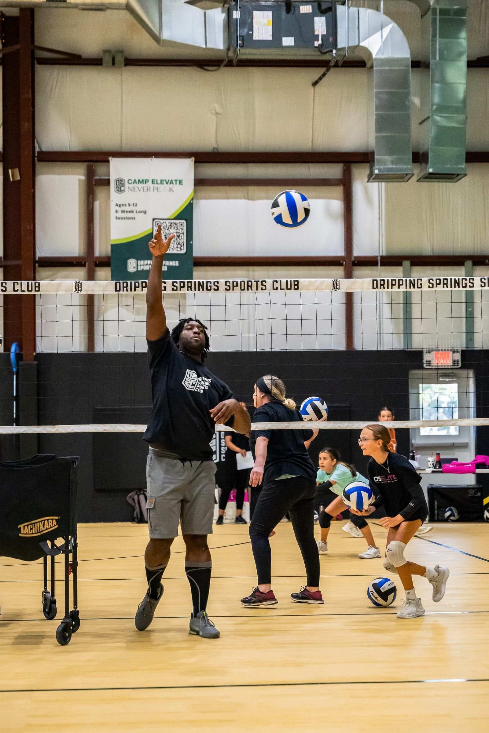 A coach serving to start a drill at the Warehouse