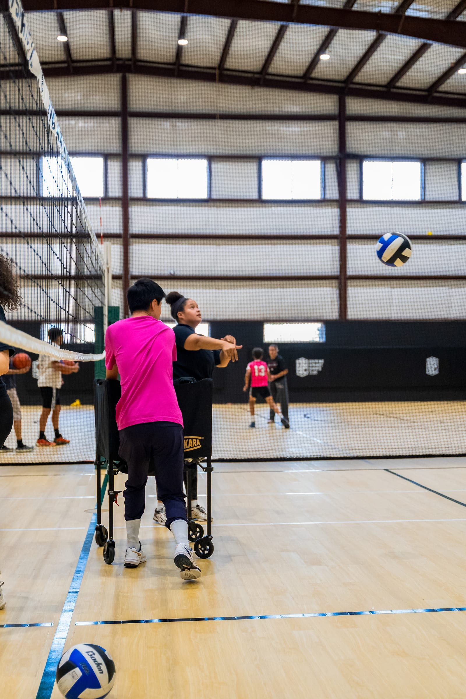 A player mid-swing at the net during hitting practice